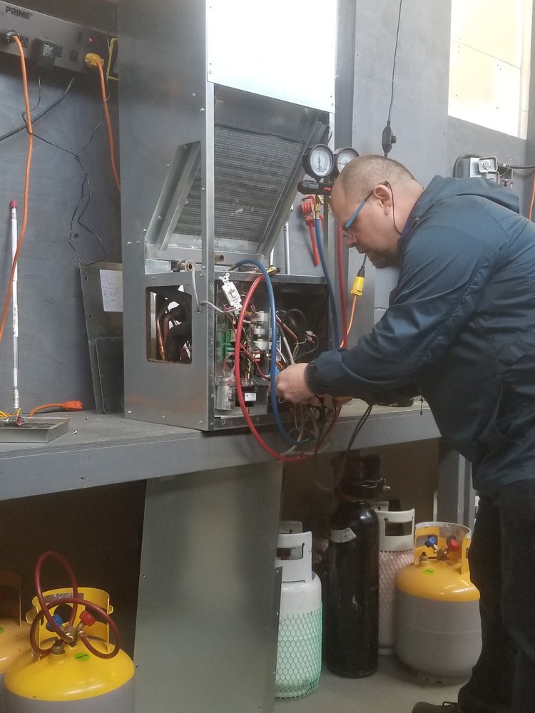 HVAC technician performing system diagnostics